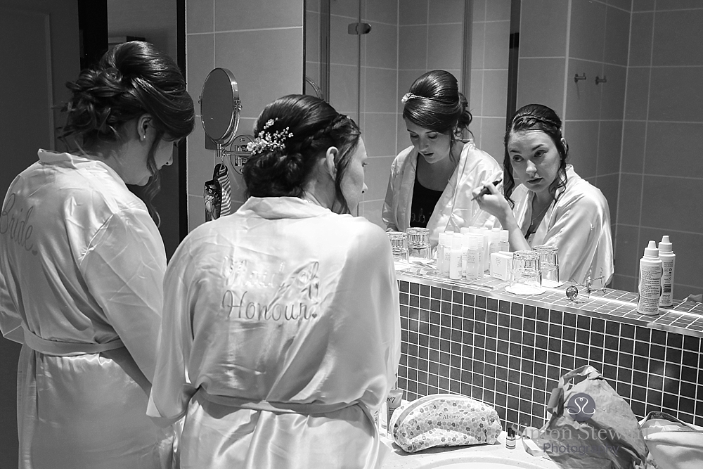 Bride looking in the mirror at the felbridge hotel