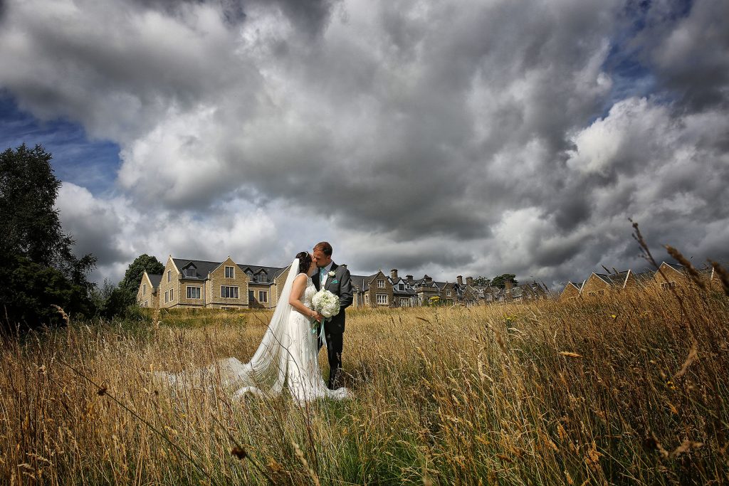 couple kissing in the grounds of South Lodge Hotel Sussex