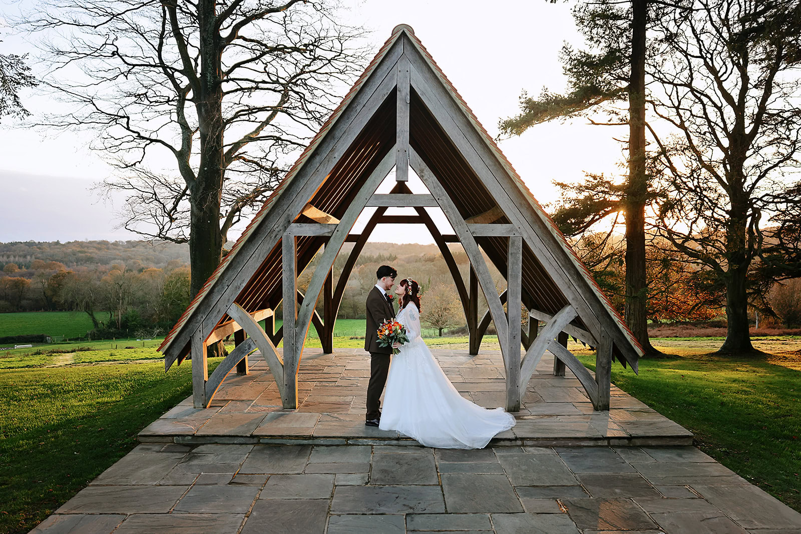 A small intimate winter wedding at Highley Manor. Bride and Groom under the pavilion at sunset. 