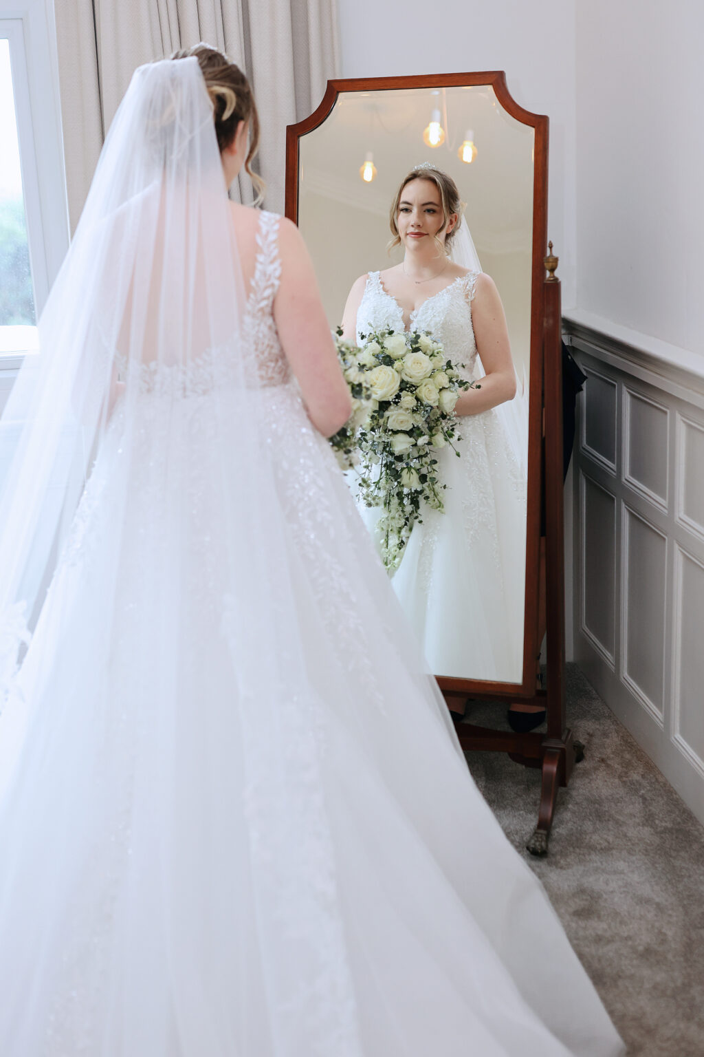 Bride getting ready on a February wedding morning at Highley Manor in Sussex
